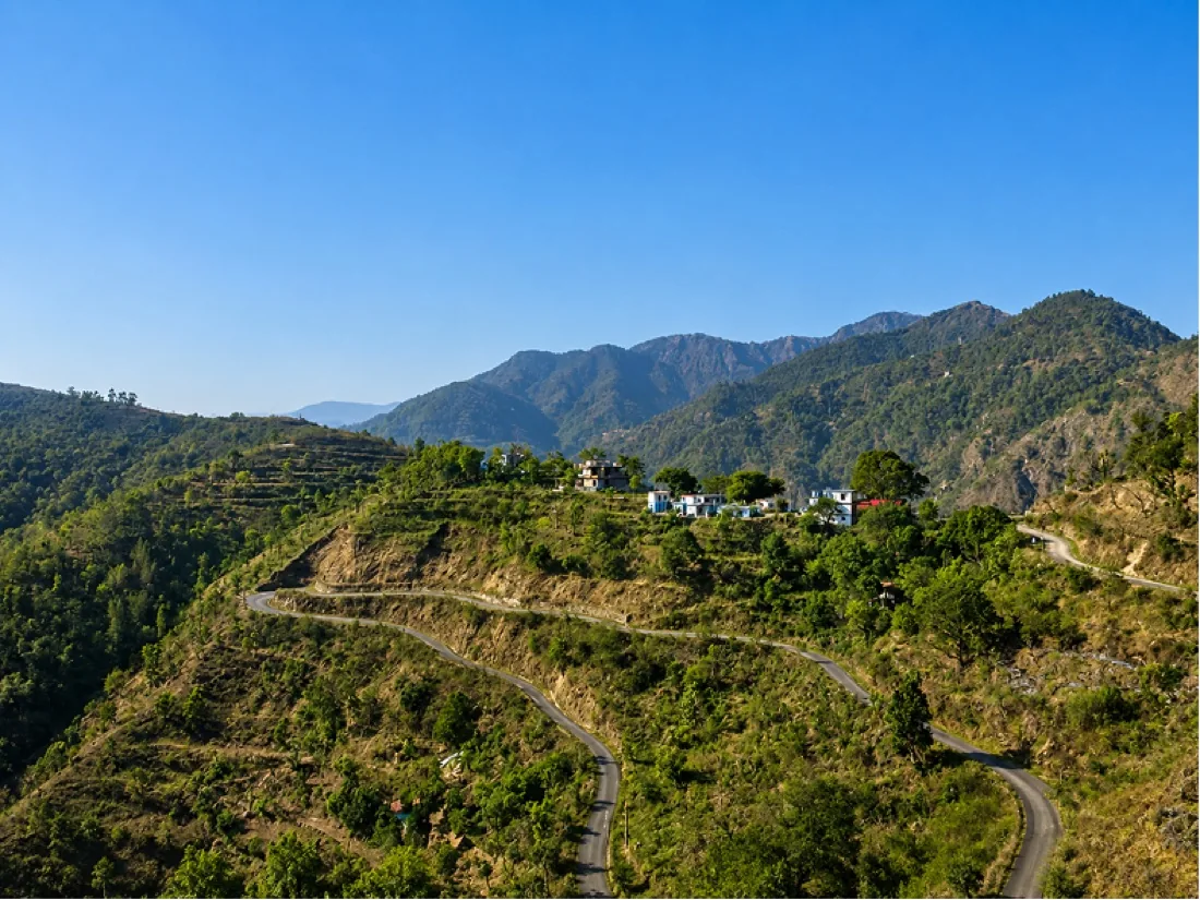 Winding mountain road through forested hills