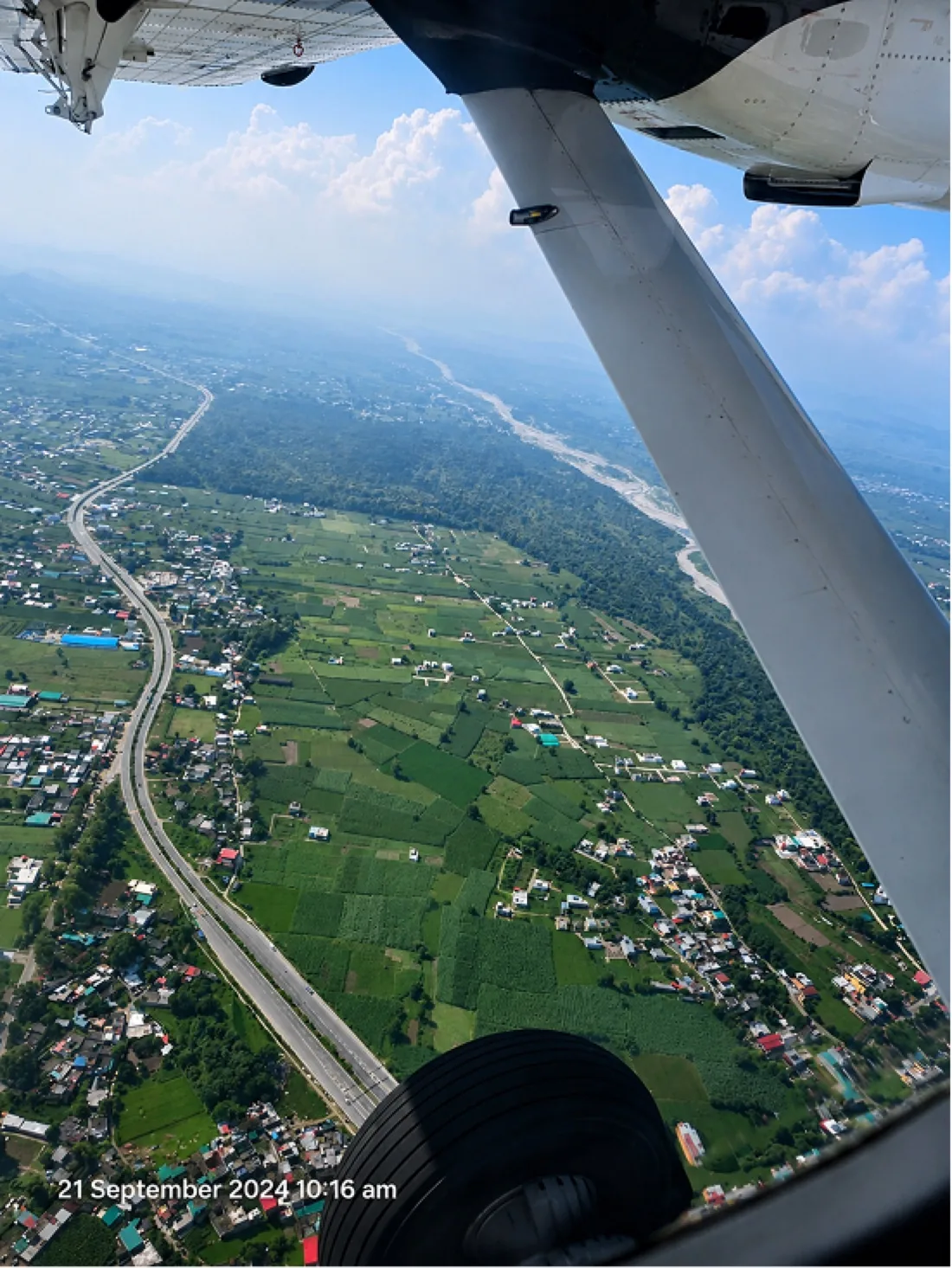 Aerial view of a valley from a small aircraft window